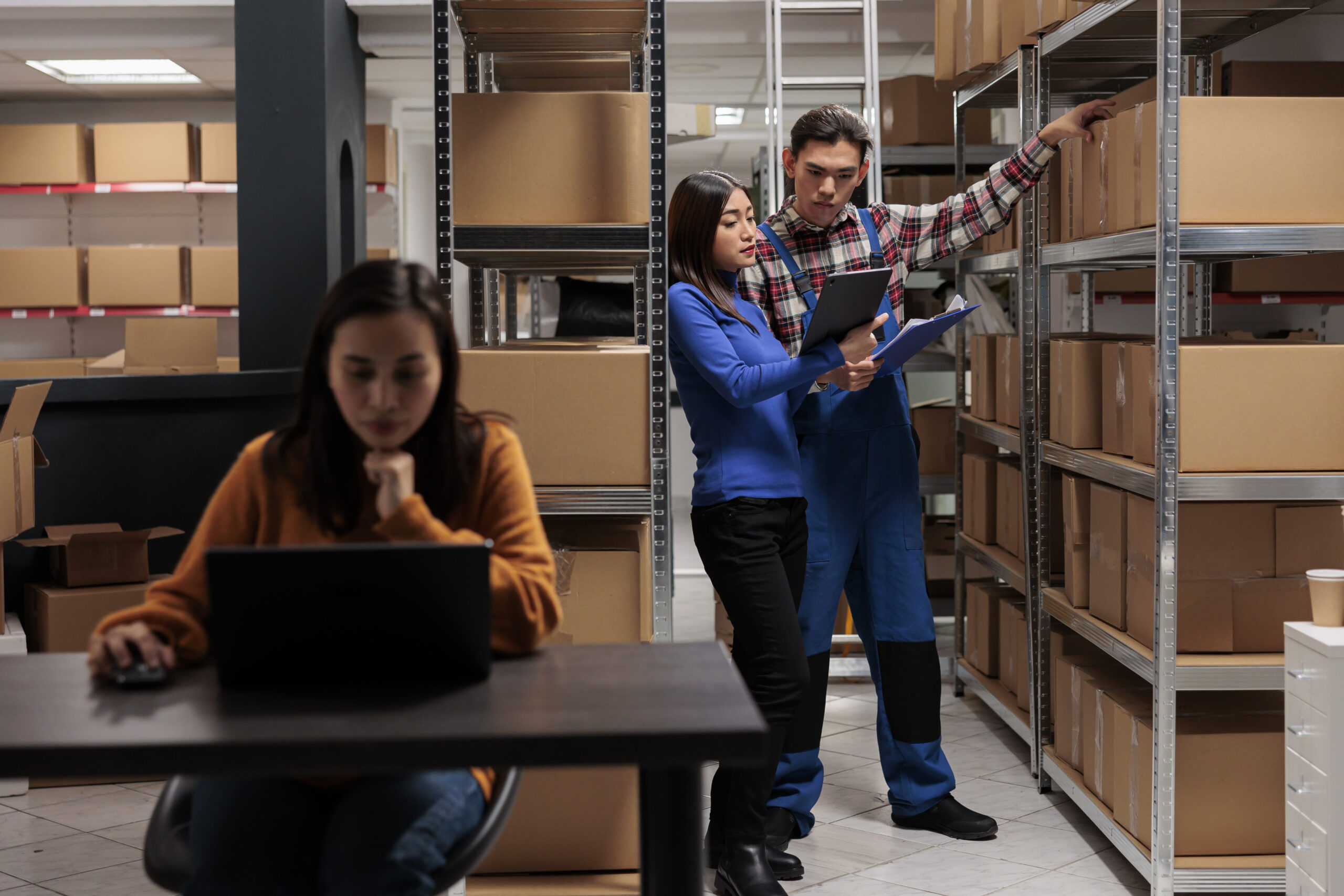 Warehouse worker and logistics manager doing products audit in storage room Warehouse worker and logistics manager doing products audit in storage room