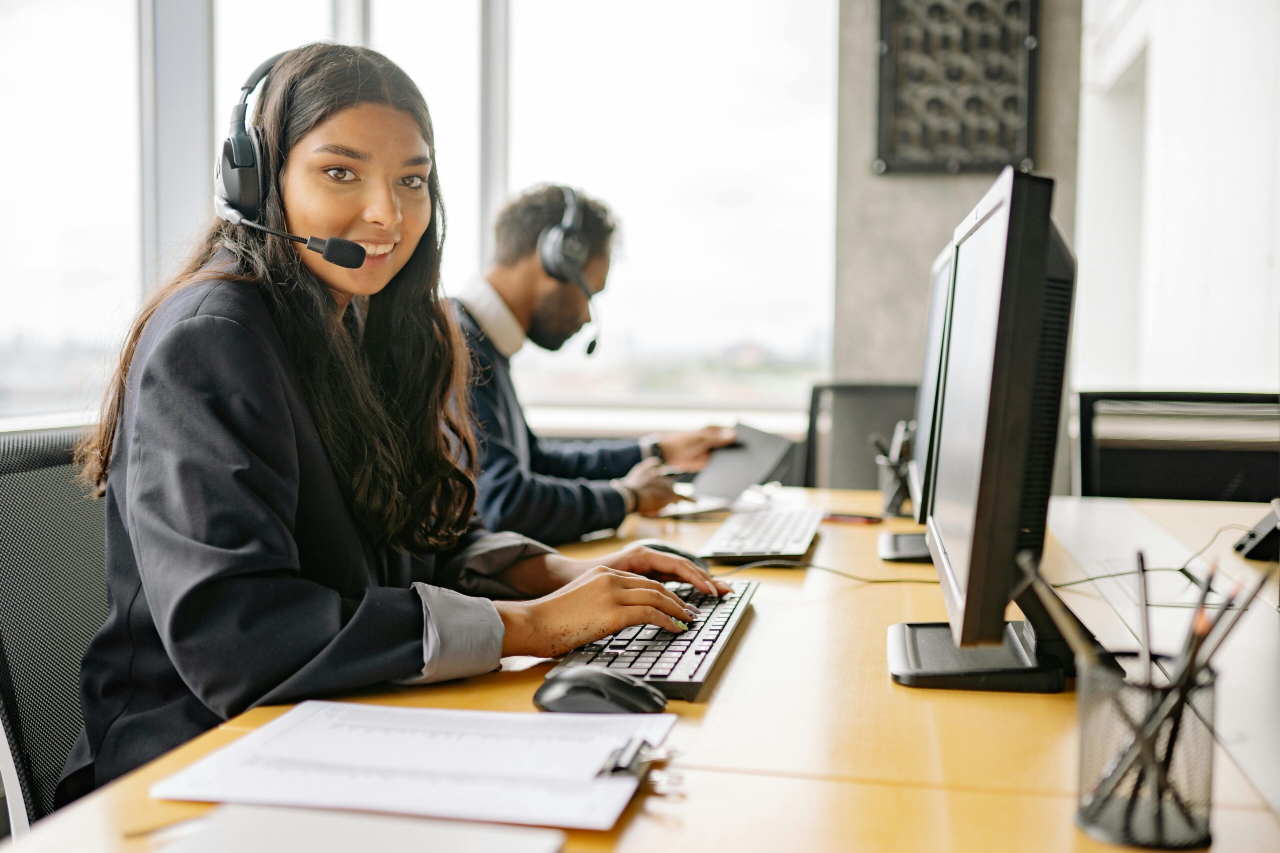 IT support specialist wearing headset looking at camera